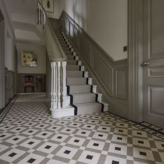 the stairs are lined with black and white tiles