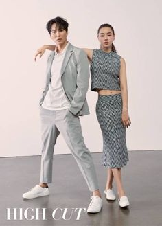 two people standing next to each other in front of a white wall with the words high cut on it