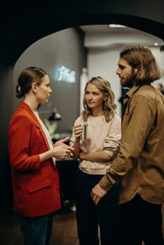 two women and a man are talking to each other