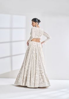 This nude net lehenga set features ivory thread, sequin, and pearl embroidery in an abstract pattern. The plunging neckline shows pearls along the v neck. The sleeves of the blouse have pearl tassels at the hem. The dupatta has a scalloped border on all four sides.From Seema Gujral’s Samode collectionDELIVERY TIMEPlease wait 8-12 weeks for your outfit to arrive.FABRIC DETAILSNetProfessional cleaning only. Pearl Tassels, Seema Gujral, Pearl Embroidery, Scalloped Border, Net Lehenga, 12 Weeks, Plunging Neckline, Body Measurements, Abstract Pattern