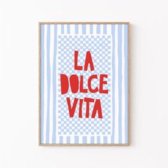 a framed poster with the words la dolce vita in red on a blue and white background