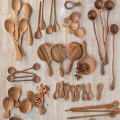 wooden spoons and other kitchen utensils laid out on a table