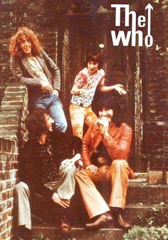 the who are sitting on steps in front of a brick building with their arms around each other