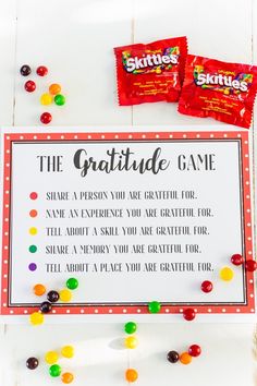 a sign that says the gratitue game next to two candy bar candies