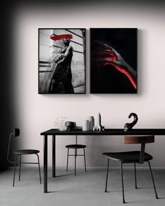 two black and white paintings hang above a table