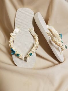 "Very beautiful Flat wedding sandals flipflop style 1/2\" heel. With beautiful workmanship, I used real shells, glass pearls, crystals, beads, pearl star fishes, and ceramic star fishes, plus more. Very dressy and simple please look at the pictures. Sizes: Small: 5.5 - 6.5 Medium: 7-8 Large: 8.5 - 9.5, X-Large: 10 - 11 Children sizes available upon request, please contact for details. Please contact for any questions ON SIZING, or ANY other concerns. FINAL SALE, NO RETURNS, NO EXCHANGES, NO EXCE Adjustable Open Toe Flip Flops For Beach Wedding, White Wedding Sandals For Beach Season, Elegant Gift Flip Flops, Flat Sandals Wedding, Bridal Flip Flops, Ceramic Star, Beach Wedding Sandals, Daytime Wedding, Crystals Beads