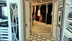 an open closet with clothes hanging in it