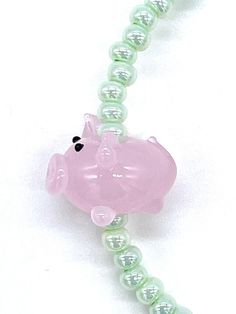 "This Pink Piglet beaded stretch bracelet gift set is handmade in the U.S.A. The mint green glass seed beads are size 6/0 and have a pearlized luster. They're strung on a one size fits all stretchy cord next to a single featured lampwork glass pig bead. The gift comes just as pictured with one bracelet, one card, and one jewelry bag. As they are each handmade, very slight variations will occur, which increases the value of each piece. Buying handmade from the U.S.A. means you get the most affordable and the fastest shipping. This gift is boxed and ships free with USPS first class mail. With ThisBeadCo.'s included signature poem this bracelet becomes an affordable gift with great meaning. The poem card reads, \"This bead is me is a sea of conformity. I will stand out, there is no doubt. And Seed Bead Bracelet, Jewelry Bag, Minimalist Bracelet, Seed Bead Bracelets, Affordable Gifts, Glass Seed Beads, Buy Handmade, Beaded Stretch Bracelet, Jewelry Bags