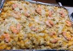 a casserole dish with shrimp and cheese in it