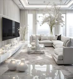 a modern living room with white furniture and flowers in vases on the coffee table