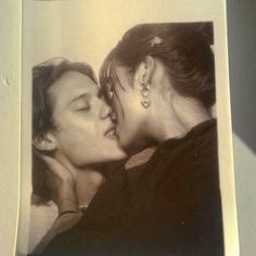 an old photo of two women kissing each other