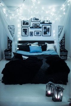 a bed room with a neatly made bed and some pictures on the wall above it