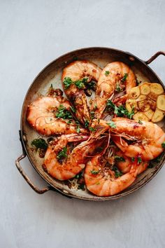 a skillet filled with cooked shrimp and vegetables