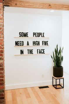 some people need a high five in the face sign next to a potted plant