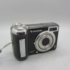 a black camera sitting on top of a white table