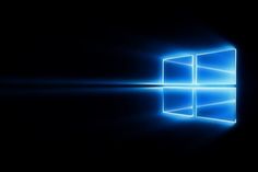 the windows logo is shown in this dark background with blue light coming from behind it