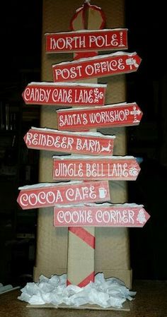 there is a sign that says north pole and post crisscross, candy cane lane, santa's workshop, ginger bar, jimmys barn, coca - cola can be