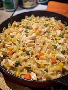 a skillet filled with pasta and vegetables