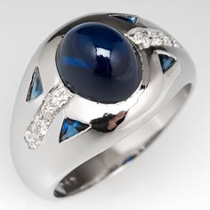 a white gold ring with blue stones and diamonds