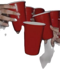 three people holding red cups in their hands with the other hand reaching out to grab one