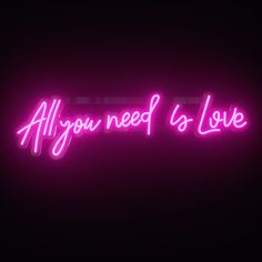 a neon sign that says all you need is love