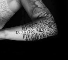 a man's arm with tattoos on it and the words xxxxxwmxxiii written in black ink