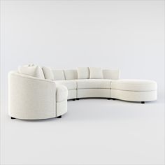 a white sectional couch sitting on top of a white floor