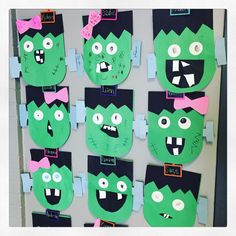 a bulletin board with paper cut out of green monster faces