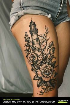 a woman's thigh with flowers and a lighthouse tattoo on it