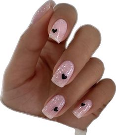 a person's hand with pink and black nail designs on it, including hearts