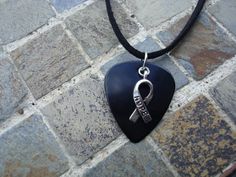 Hope Ribbon Guitar Pick Necklace,  Melanoma, Mourning. Black with Hope Ribbon Charm. Adjustable Hypoallergenic Black Necklace, Black Music-themed Jewelry For Gift, Music-themed Black Jewelry Gift, Ribbon Meaning, Pick Necklace, Mens Jewelry Box, Guitar Pick Necklace, Hope Necklace, Having No Friends