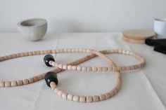 three wooden beads on a white table cloth