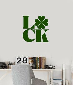 a wall decal with the word luck and shamrock leaves