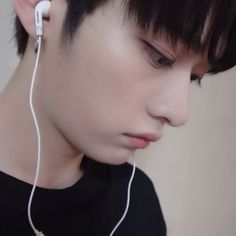 a young man with ear buds on his ears