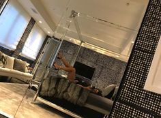 a woman laying on top of a bed next to a tv in a living room