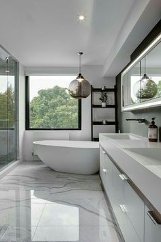 a bathroom with a large bathtub next to a walk in shower and two sinks