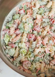 a bowl filled with pasta and broccoli on top of a table