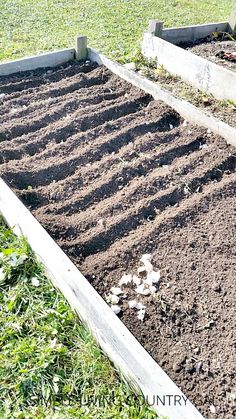 three raised garden beds with dirt in them