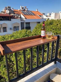 a bottle of beer sitting on top of a balcony