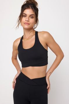 Wrap it up. A moderate support, double-layer bra designed with a sleek racerback. Made in our 4-way stretch Dream Tech eco-conscious fabrication that is compressive, moisture-wicking, quick-drying, and anti-odor. | Evie Wrap Front Bra in Black Supportive Black Compressive Sports Bra, Black Compressive Versatile Sports Bra, Black Sports Bra With 4-way Stretch, Black Strappy Bra-friendly Activewear, Black V-neck Activewear With Built-in Bra