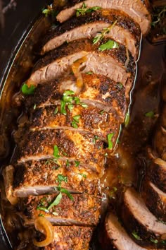 sliced pork with onions and herbs in a skillet