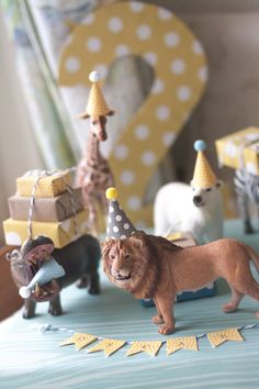 a lion figurine is standing in front of other toy animals on a table