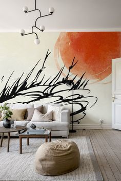 a living room with a couch, coffee table and large painting on the wall behind it