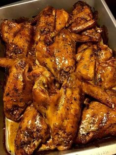 chicken wings in a pan with seasoning on top