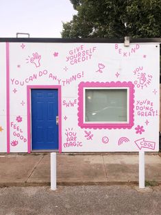 a white building with pink and blue painted on it