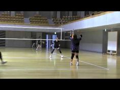 several people playing volleyball on an indoor court