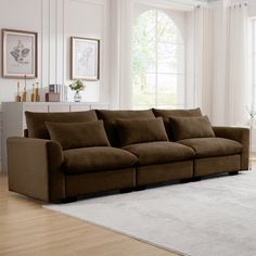 a living room scene with focus on the couch and rug in front of the window