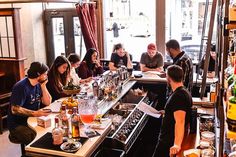 a group of people sitting at a bar