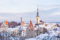 an aerial view of a city with snow on the ground and buildings in the foreground