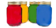 three jars with different colored liquids in them